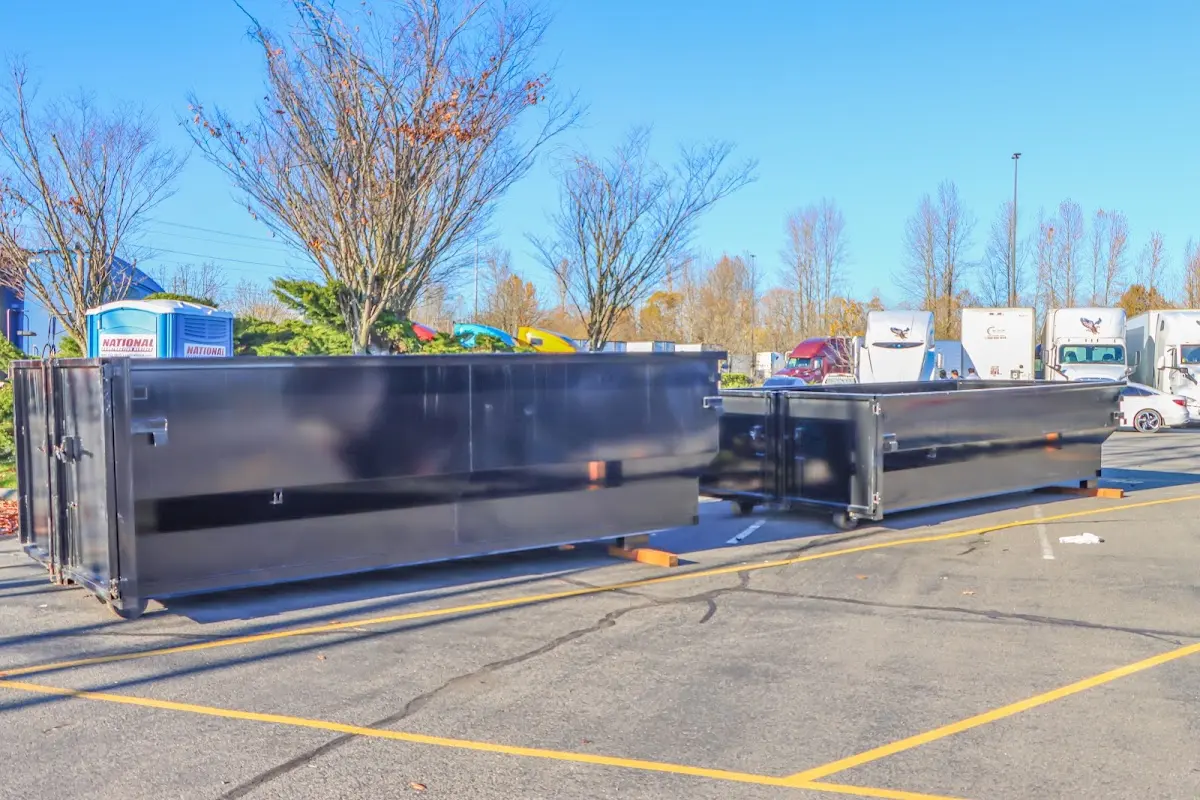 Professional dumpster rental service with roll-off container on residential driveway in Deerfield